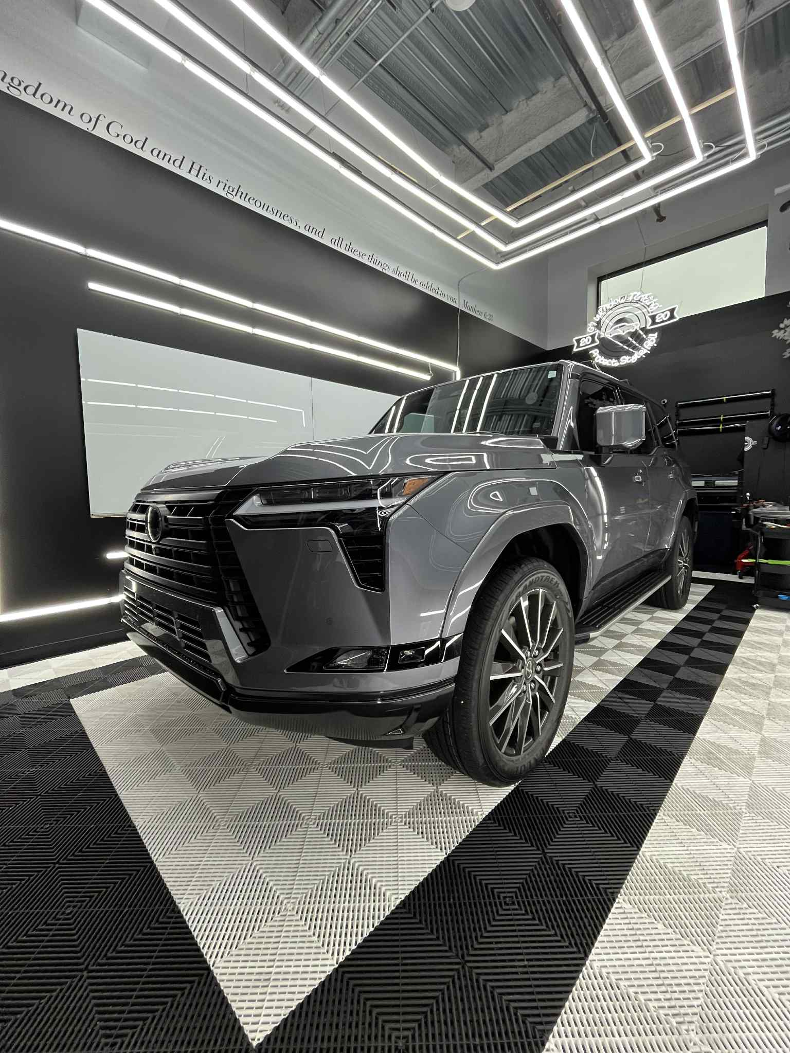 Luxury SUV with professional window tinting in modern G1 Window Tinting shop